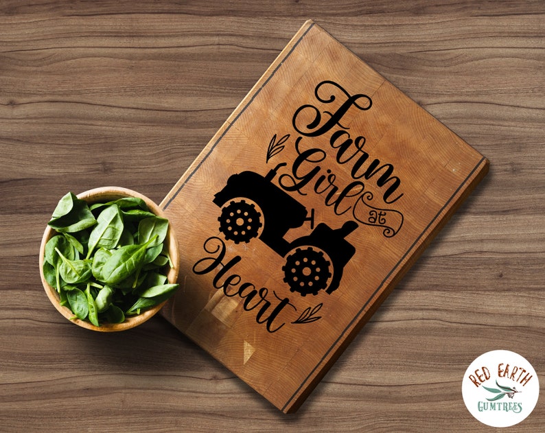 May include: A wooden cutting board with the text "Farm Girl at Heart" and a silhouette of a tractor.