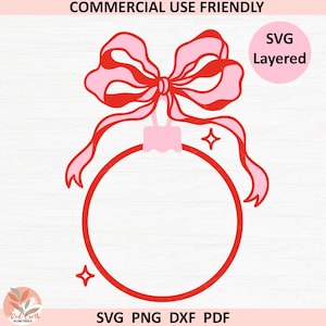 May include: A red and pink Christmas ornament design with a bow and ribbons. The design includes a circle for customization, with the text "COMMERCIAL USE FRIENDLY" at the top and "SVG PNG DXF PDF" at the bottom. A pink circle with the text "SVG Layered" is on the right.