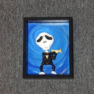 May include: A framed painting of a cartoon skeleton wearing a black tuxedo and playing a gold trumpet. The background is a swirling blue color. The painting is signed "S.D'orazio".