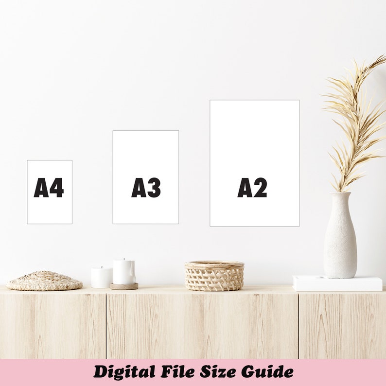 May include: Three white rectangular prints labeled A4, A3, and A2 are displayed on a white wall. Below, a wooden cabinet holds candles, a woven basket, and a vase with dried plants. The text "Digital File Size Guide" is at the bottom.