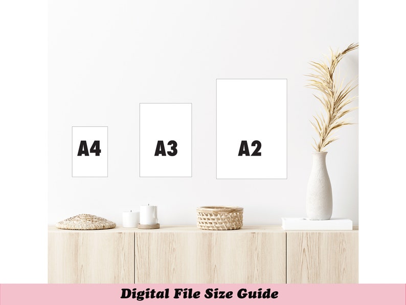 May include: A wall-mounted display of three white rectangular frames labeled A4, A3, and A2, showcasing digital file sizes. The frames are arranged on a white wall above a wooden cabinet. A vase with dried plants is on the right.