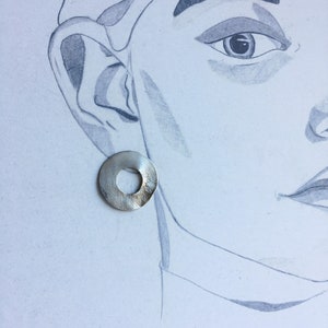 large round ear studs in silver with a subtle surface structure, an eye-catcher on the ear, simple and yet a statement image 5