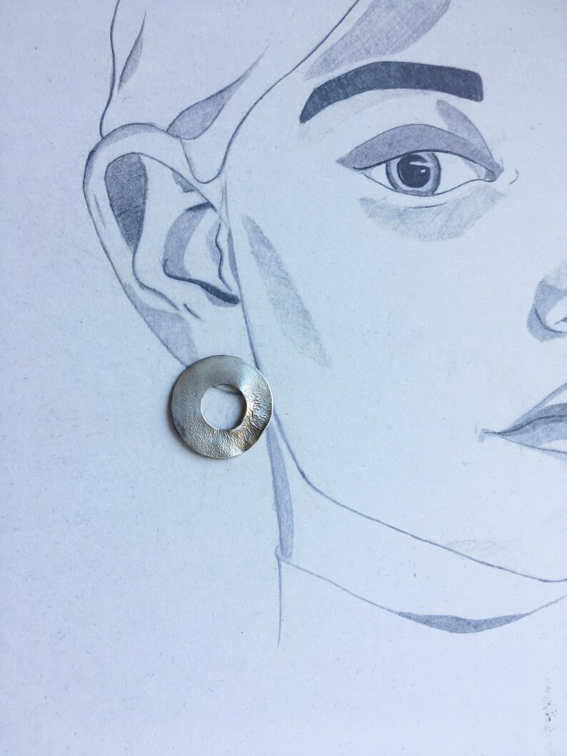 large round ear studs in silver with a subtle surface structure, an eye-catcher on the ear, simple and yet a statement image 5