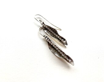 Hanging earring with a line of silver beads in an open pod made of 935 silver, statement, unique and handmade