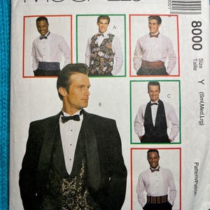 May include: A McCall's sewing pattern for a tuxedo, featuring a black tuxedo jacket, a white dress shirt with a bow tie, and a patterned vest. The pattern number is 8000.
