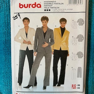 May include: A Burda pantsuit sewing pattern package. The package features images of women wearing pantsuits in white, gray, and yellow. The package includes the number 8279 and the text "PANTSUIT".