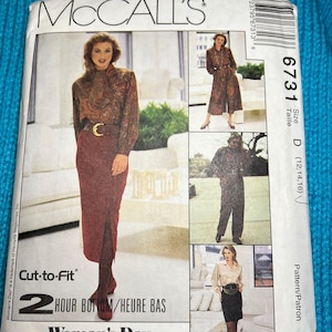 May include: McCall's sewing pattern for a two-hour bottom, size D (12-14-16). The pattern features a woman wearing a long-sleeved blouse with a paisley print and a burgundy skirt with a slit. The pattern also includes a pair of wide-leg trousers and a skirt with a belt.