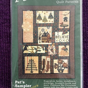 May include: A packaged quilt pattern titled "I Believe" by Pat Sloan & Co. The sampler series #111 features a Christmas-themed quilt design with various squares depicting snowflakes, houses, stockings, and fairies. The package is green with brown accents.