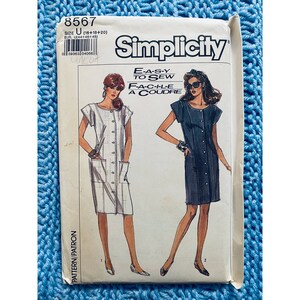 May include: Simplicity sewing pattern number 8567 for sizes 16, 18, and 20. The pattern includes instructions for making two dresses, one white and one blue. The pattern is labeled "Easy to Sew" and "Facile a Coudre".