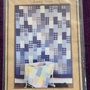 May include: A quilt pattern titled "The Quick Brick Quilt" with a patchwork design in shades of blue and white. The image shows a finished quilt and a smaller quilt in a crib. The text reads "Quick and simple, quilted as you go!"
