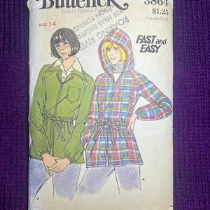 May include: A Butterick 3864 sewing pattern envelope for a jacket with a drawstring waist. The illustration shows two versions: one in solid green and one in a red, blue, and green plaid with a hood. Text includes Size 14, Fast and Easy.