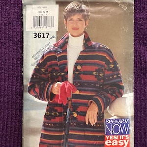 May include: A sewing pattern package featuring a woman wearing a colorful patterned jacket. The package includes the text "3617" and "see & sew NOW YES! IT'S easy". The jacket has a geometric design with red, blue, and brown stripes.