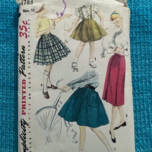 May include: Vintage Simplicity pattern envelope featuring illustrations of skirts and tops. The envelope is cream-colored with the text "Simplicity Printed Pattern" and the price "35¢". The size is 10.