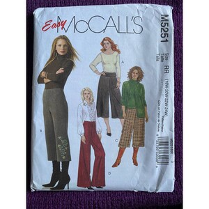 May include: A sewing pattern for women's pants. The pattern includes three different styles of pants: wide-leg, cropped, and cuffed. The pattern is for sizes 18W-20W-22W-24W.