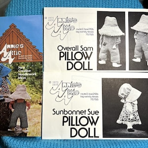 May include: A set of three vintage sewing patterns for pillow dolls. The patterns are for Overall Sam, Sunbonnet Sue, and a doll with a blue bonnet. The patterns are from Amie's Attic, located in Big Sandy, Texas.