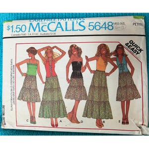 May include: A sewing pattern for a set of tops and a skirt. The pattern is for misses sizes 6-8 and is labeled "Quick & Easy". The pattern is from McCall's and the number is 5648.