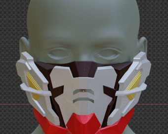 May include: A white, red, and gold face mask with geometric designs. The mask has a black center section with a small, round, orange light.