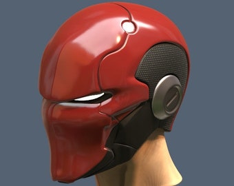 May include: A red and black helmet with a futuristic design. The helmet has a visor and a black mesh panel on the side.