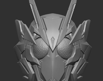 May include: A gray, three-dimensional digital model of a full-face helmet featuring a sharp, angular design with two prominent, pointed antennae extending upward and large, circular, textured eye lenses on the front of the mask.