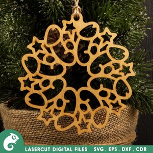 May include: A laser cut wooden ornament shaped like a snowflake with intricate details. The ornament is made of light brown wood and has a rustic, vintage look.
