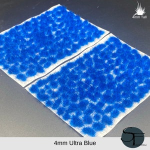 May include: Two sheets of 4mm tall ultra blue static grass tufts on a white backing. The grass is a bright, vibrant blue.