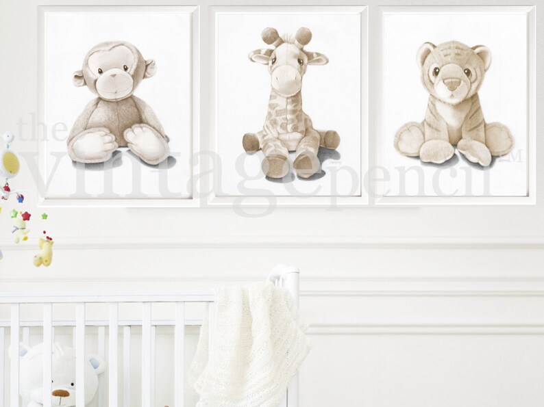 May include: Three framed prints of watercolor illustrations of stuffed animals. The animals are a monkey, a giraffe, and a tiger. All three animals are sitting and facing forward. The background is white.