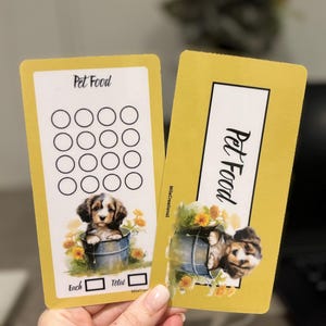 May include: Two yellow pet food tracker cards with a cute puppy illustration. The card on the left has a grid of 16 circles for tracking pet food. The card on the right has the text "Pet Food" and a puppy illustration. Both cards have the text "Mila Creations".