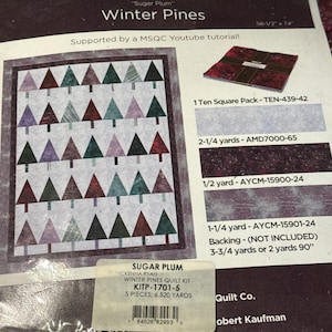 May include: A Missouri Star Quilt Co. Winter Pines quilt kit package featuring a pattern of triangular trees in shades of purple, green, and red. The packaging includes text, a quilt illustration, fabric swatches, and a barcode label with the text SUGAR PLUM WINTER PINES QUILT KIT KITP-1701-5.