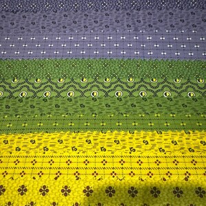 May include: A collection of fabric swatches arranged in horizontal rows, featuring various patterns including small floral prints, geometric dots, and scalloped borders in shades of dark blue, light blue, green, and bright yellow with pink accents.