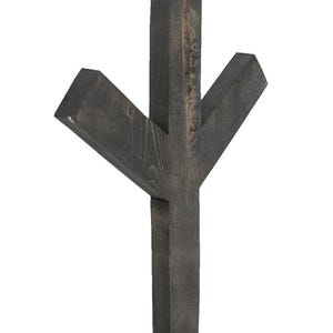May include: A dark stained wooden wall decoration in a Y shape. The wood grain is visible, and the piece has a rustic, handcrafted appearance. The design features a vertical post with two angled arms extending outwards.