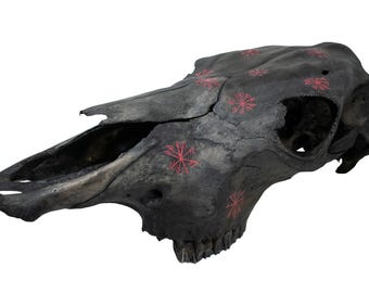 blackened cow skull connection to the gods stave