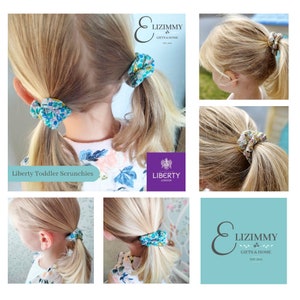 May include: A selection of Liberty toddler scrunchies, featuring floral patterns in blue, green, and pink. The image shows different angles of the scrunchies in use. The image includes the brand name "ELIZIMMY GIFTS & HOME" and the "LIBERTY LONDON" logo.