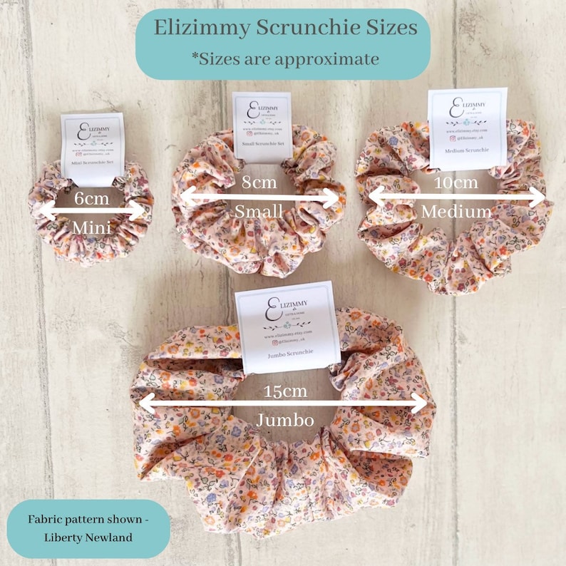 May include: Four scrunchies in different sizes, with a floral print. The scrunchies are labeled with their size in centimeters: 6cm Mini, 8cm Small, 10cm Medium, and 15cm Jumbo. The fabric pattern is Liberty Newland.