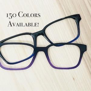 May include: Two pairs of black eyeglasses with purple and blue tinted lenses. The text "150 COLORS AVAILABLE!" is visible in the image.
