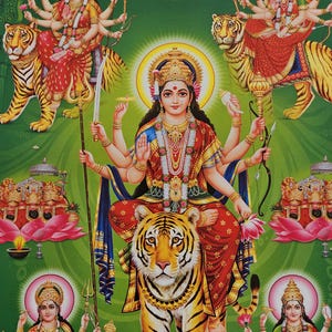 May include: A vibrant illustration of a Hindu goddess seated on a tiger, surrounded by other deities. The central figure wears a crown and multiple arms, holding various objects. The artwork features a green background with gold accents and lotus flowers.
