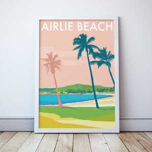 May include: A retro-style poster with the text "Airlie Beach" in white letters on a pink background. The poster features a beach scene with palm trees, a blue bay, and a green hill in the background.