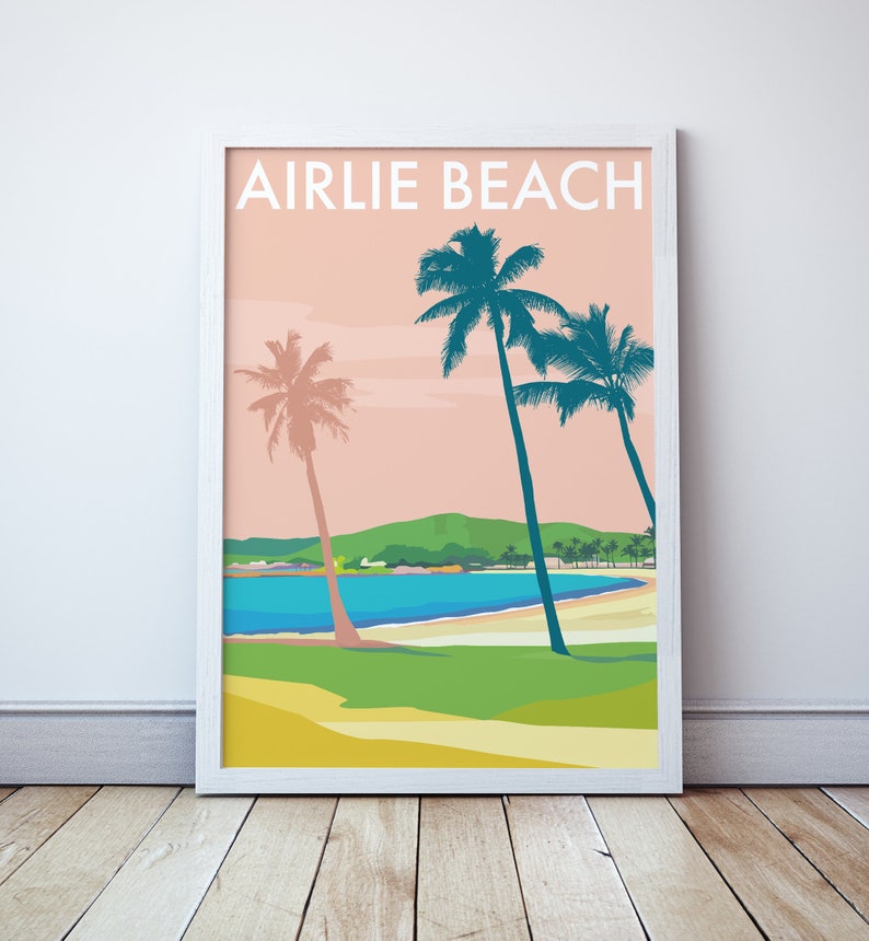 May include: A retro-style poster with the text "Airlie Beach" in white letters on a pink background. The poster features a beach scene with palm trees, a blue bay, and a green hill in the background.