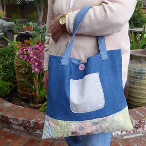 Handmade denim shoulder bag embellished with vintage quilt pieces, Japanese futon fabrics, and appliqué.
