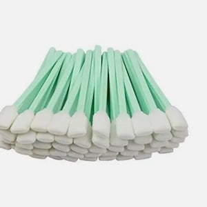 May include: A large stack of green and white cleaning swabs. The swabs are made of a soft, absorbent material and are ideal for cleaning delicate surfaces.