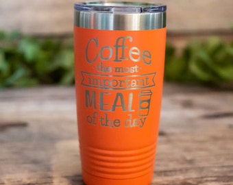 May include: Orange stainless steel tumbler with a silver lid and the text "Coffee the most important meal of the day" engraved on the side.