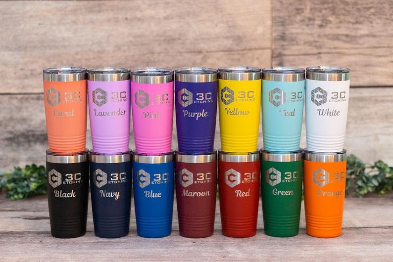 May include: A set of 12 stainless steel tumblers with various colors and engraved text. The tumblers are arranged in two rows of six. The text on the tumblers includes "3C Etching", "Coral", "Lavender", "Pink", "Purple", "Yellow", "Teal", "White", "Black", "Navy", "Blue", "Maroon", "Red", "Green", and "Orange".
