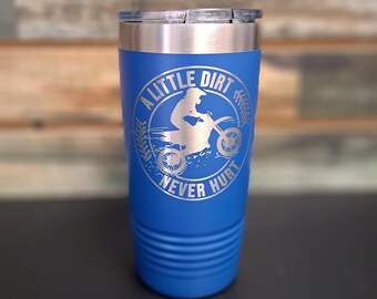 May include: A blue stainless steel tumbler with a silver lid. The tumbler has a white design of a person riding a dirt bike with the text "A Little Dirt Never Hurt".