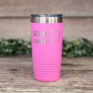May include: Pink stainless steel tumbler with a white inscription that reads "Bitch Switch" and a graphic of an on/off switch.
