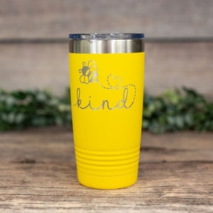 May include: Yellow stainless steel tumbler with a bee and heart design and the word "kind" engraved on the side.