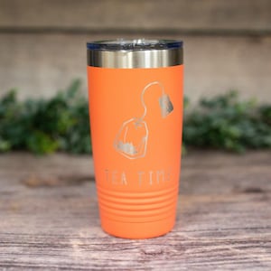 May include: Orange stainless steel tumbler with a tea bag graphic and the text "TEA TIME" engraved on the side.