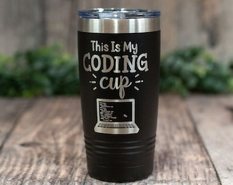 May include: Black stainless steel tumbler with a silver lid. The tumbler has the text "This Is My Coding cup" with a laptop graphic below the text.