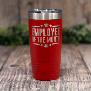 May include: Red stainless steel tumbler with a silver lid and the text "EMPLOYEE OF THE MONTH" with stars on either side.