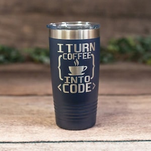 May include: A navy blue stainless steel tumbler with a silver lid. The tumbler has the text "I turn coffee into code" engraved on it, with a stylized coffee cup and code brackets.