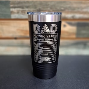 May include: Black stainless steel tumbler with a silver lid. The tumbler has a white inscription that reads "DAD Nutrition Facts Serving Size: 1 Amazing Man" with a list of nutritional facts below.