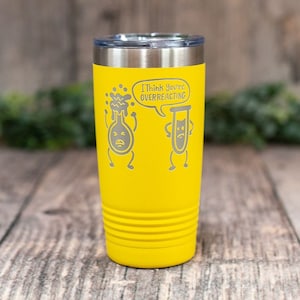 May include: Yellow stainless steel tumbler with a science-themed design. It features a cartoon beaker and flask with the text "I think you're overreacting".